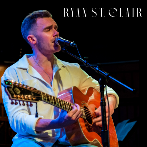 A person is playing an acoustic guitar and singing into a microphone, with 