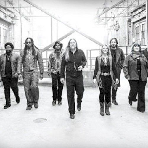 A diverse group of ten people walking confidently in an urban alley, suggesting unity and purpose in a candid black-and-white shot.