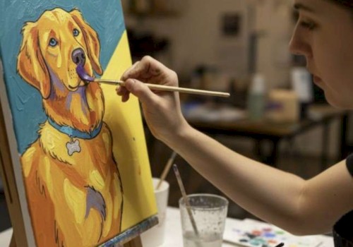 A person paints a colorful, cartoon-style portrait of a golden retriever dog on a canvas in an art studio.