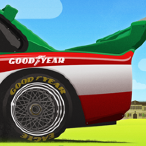 A racing car with a Goodyear tire, a green and black rear wing, and an open cockpit on a grassy background with trees and a house.