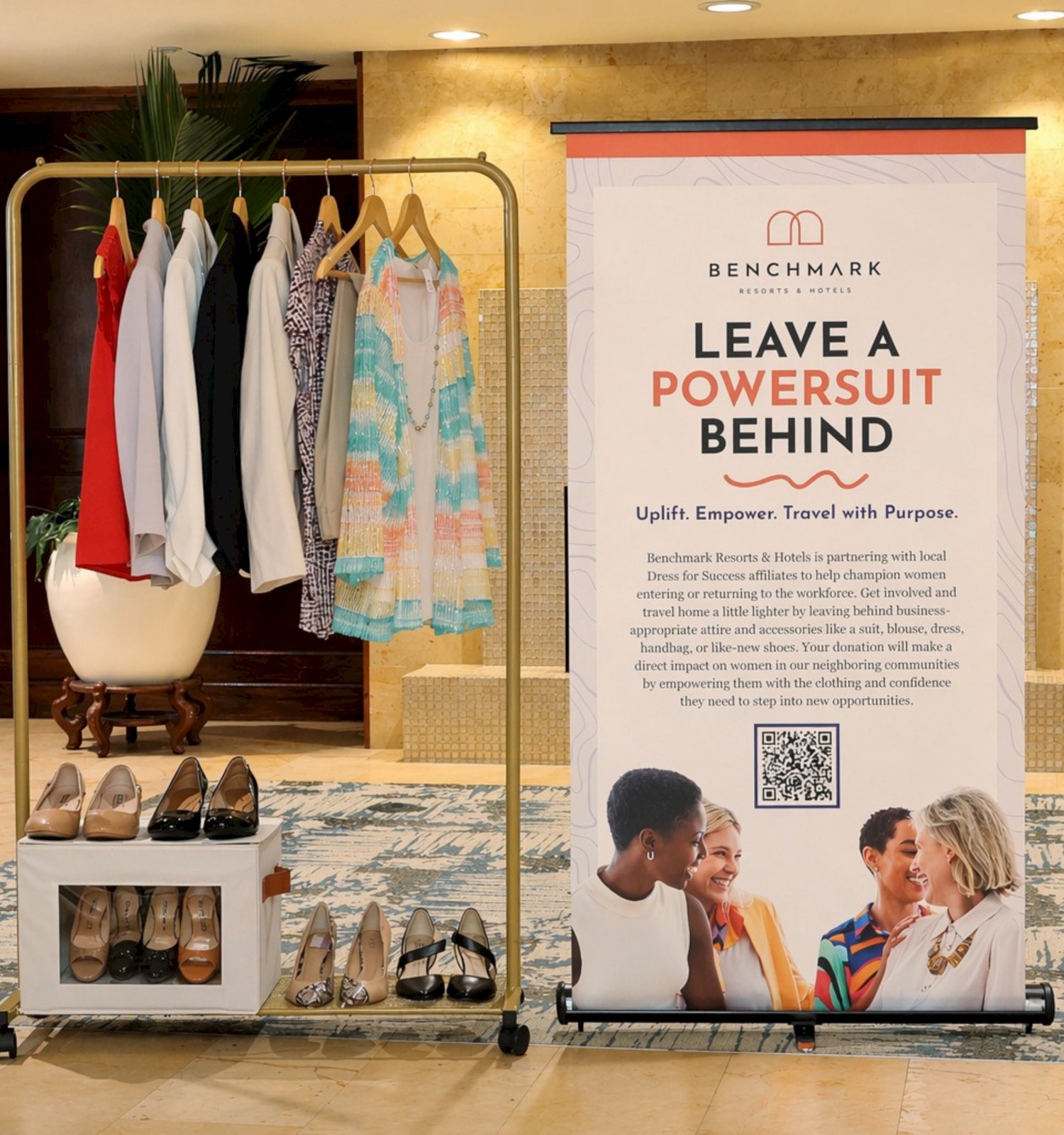 A display promoting women's empowerment through professional attire and donations at Benchmark Resorts & Hotels.