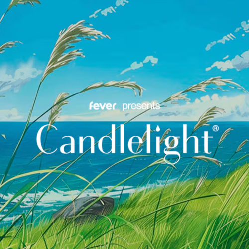 A scenic coastal landscape with green grass, tall reeds, blue ocean, and partly cloudy sky, advertising an event called Candlelight.