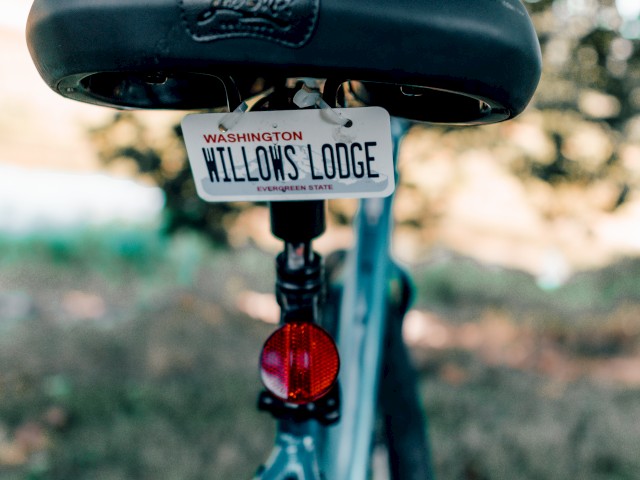 The image shows the back of a bicycle with a Washington license plate reading 