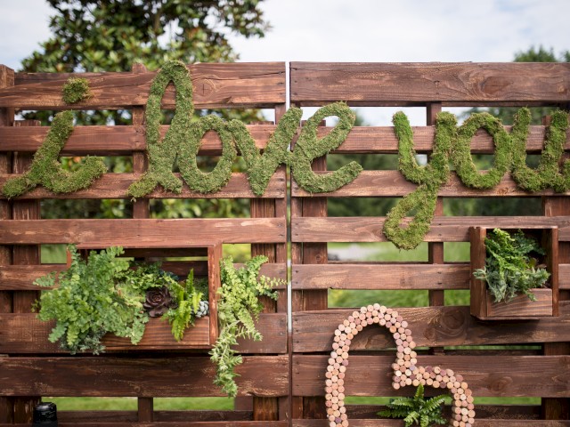 A wooden outdoor decoration features moss-covered 