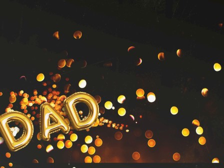 The image shows golden balloons spelling 